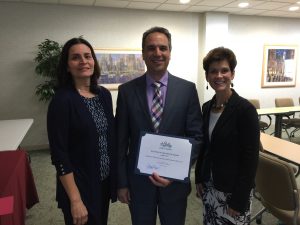 Jean McCann, Chair of the Member Services Committee and Stacey Bruzzese, President present the Business of the Month Award to Paul Magliochetti of SSJM Attorneys.