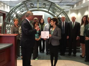 Stacey Bruzzese, President/CEO, Greater Haverhill Chamber of Commerce presents the March Business of the Month Award to Scott Cote, Chief Executive Officer, Pentucket Bank while bank team looks on.