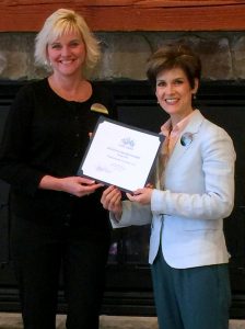 # Photo Caption: Kristin Perry, CFO at Atkinson Resort & Country Club accepts the Business of the Month Award from Chamber President/CEO, Stacey Bruzzese