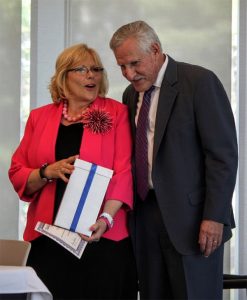 Massachusetts Commissioner of Higher Education, Carlos E. Santiago, presents Dianne McDermott Cerasuolo with an MCO Course of Distinction Award