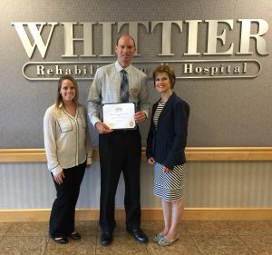 Kelly Michal, Membership Coordinator (left) and Stacey Bruzzese, President & CEO (right) of the Greater Haverhill Chamber present the Business of the Month Award to Bob Iannacco, Administrator of Whittier Rehabilitation Hospital
