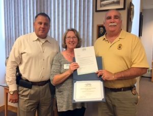 Deputy Chief, Anthony Haugh and Chief Alan DeNaro are presented with the September Award by Melissa Seavey, GHCC Event Coordinator
